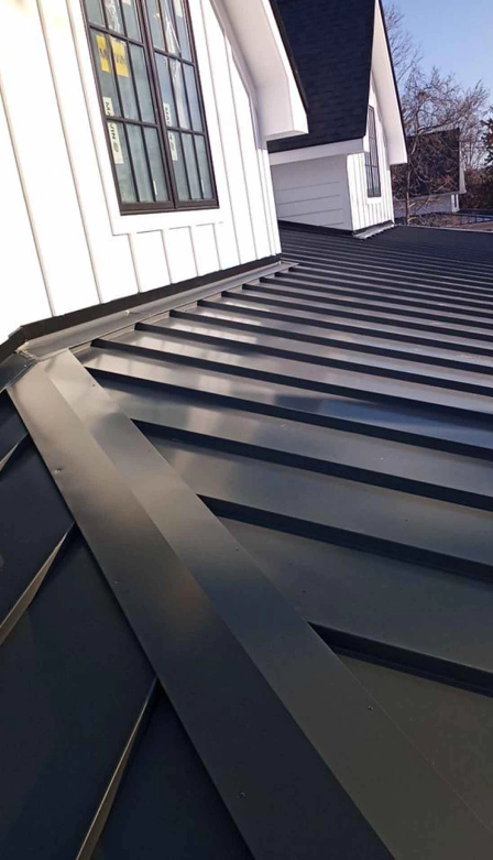 newly installed black metal roofing